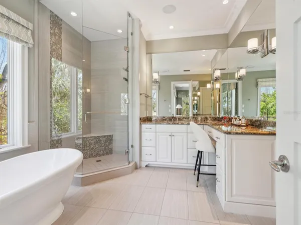 a view of a patio with chairs and potted plants