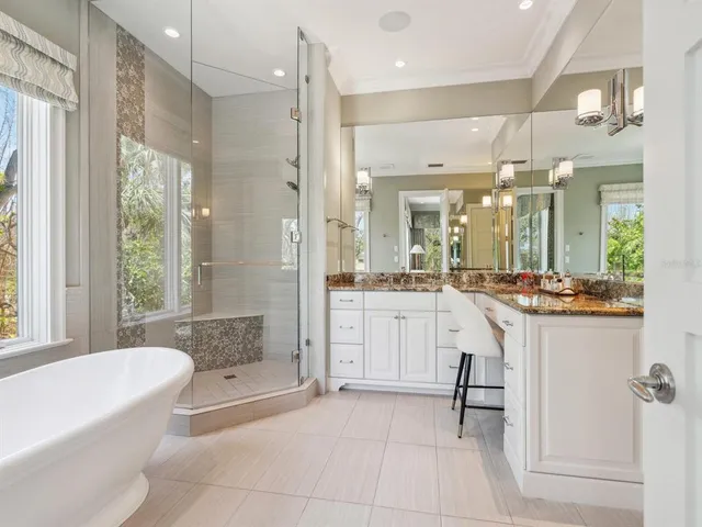 a view of a patio with chairs and potted plants