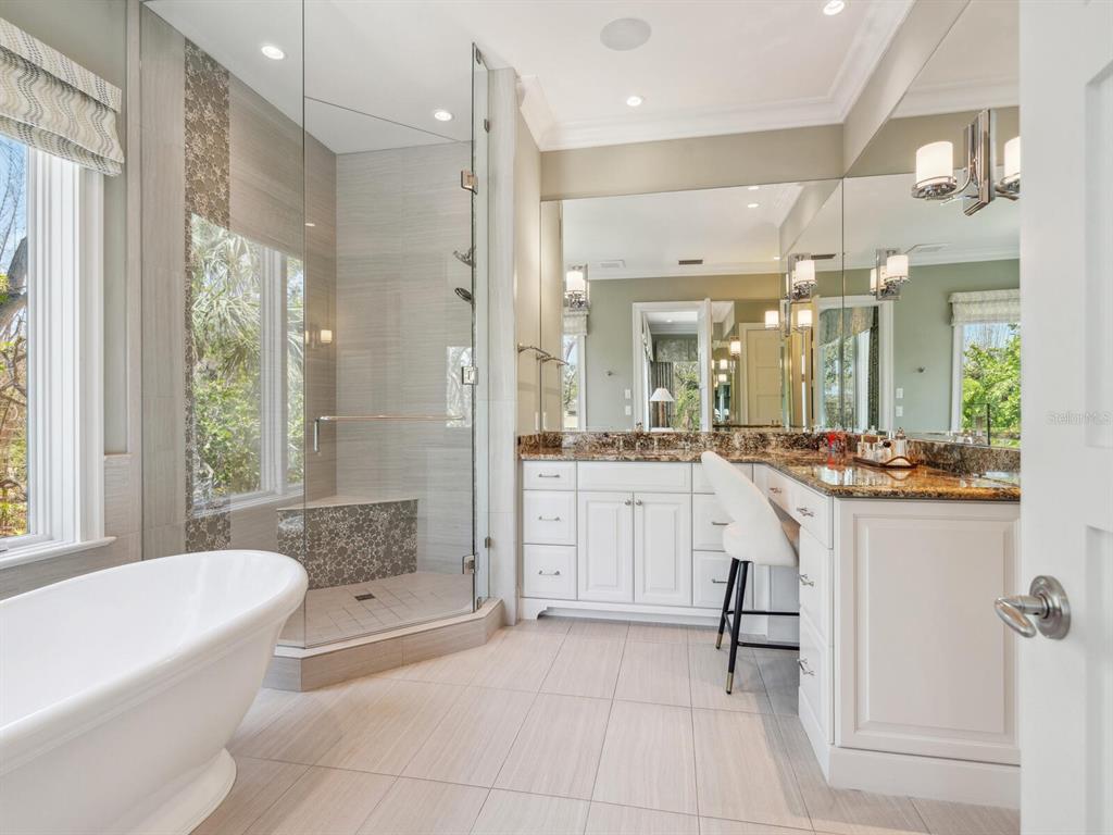 7333 Point Of Rocks Road Sarasota, FL 34242 - Photo 26 of 81 a bathroom with a granite countertop sink a toilet a mirror and bathtub
