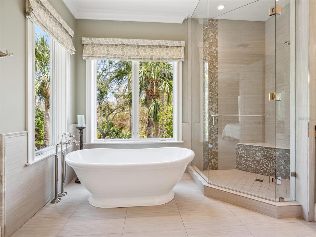 7333 Point Of Rocks Road Sarasota, FL 34242 - Photo 27 of 81 a bathroom with a large tub a shower and view