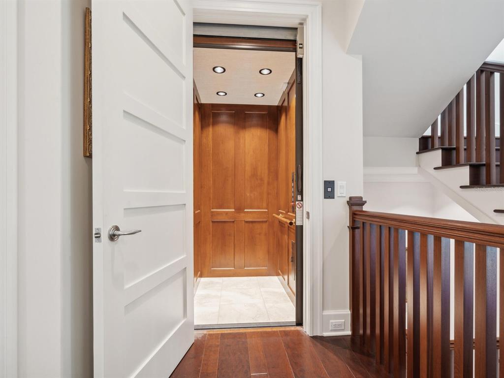 7333 Point Of Rocks Road Sarasota, FL 34242 - Photo 29 of 81 a view of a hallway with wooden floor and staircase