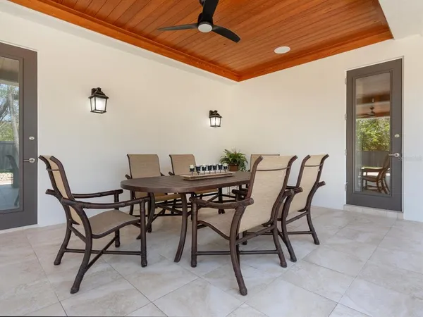 a view of a dining room with furniture wooden floor and chandelier