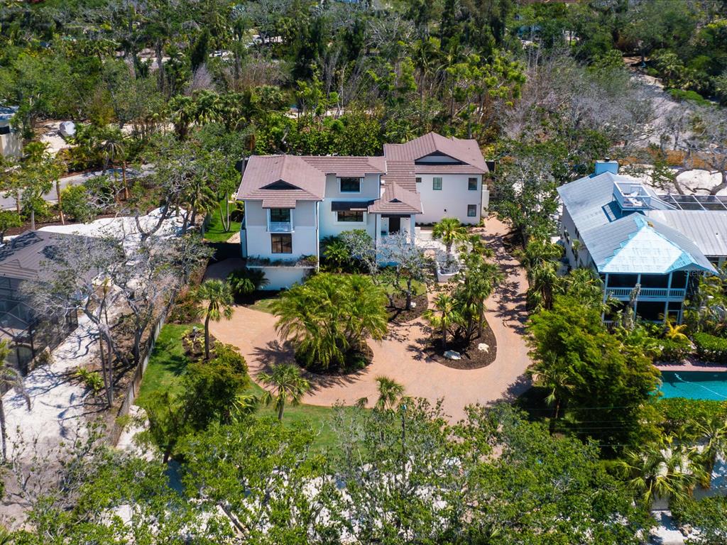 7333 Point Of Rocks Road Sarasota, FL 34242 - Photo 4 of 81 an aerial view of a house with a yard and lake view