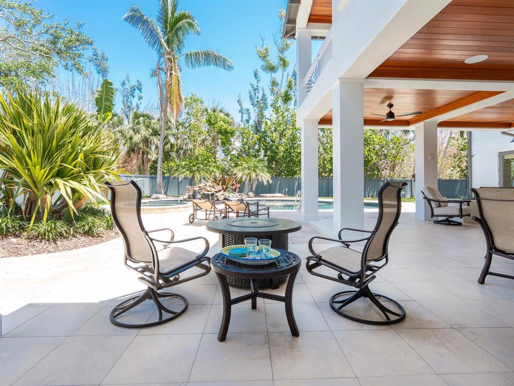 7333 Point Of Rocks Road Sarasota, FL 34242 - Photo 42 of 81 a view of a patio with chairs and potted plants