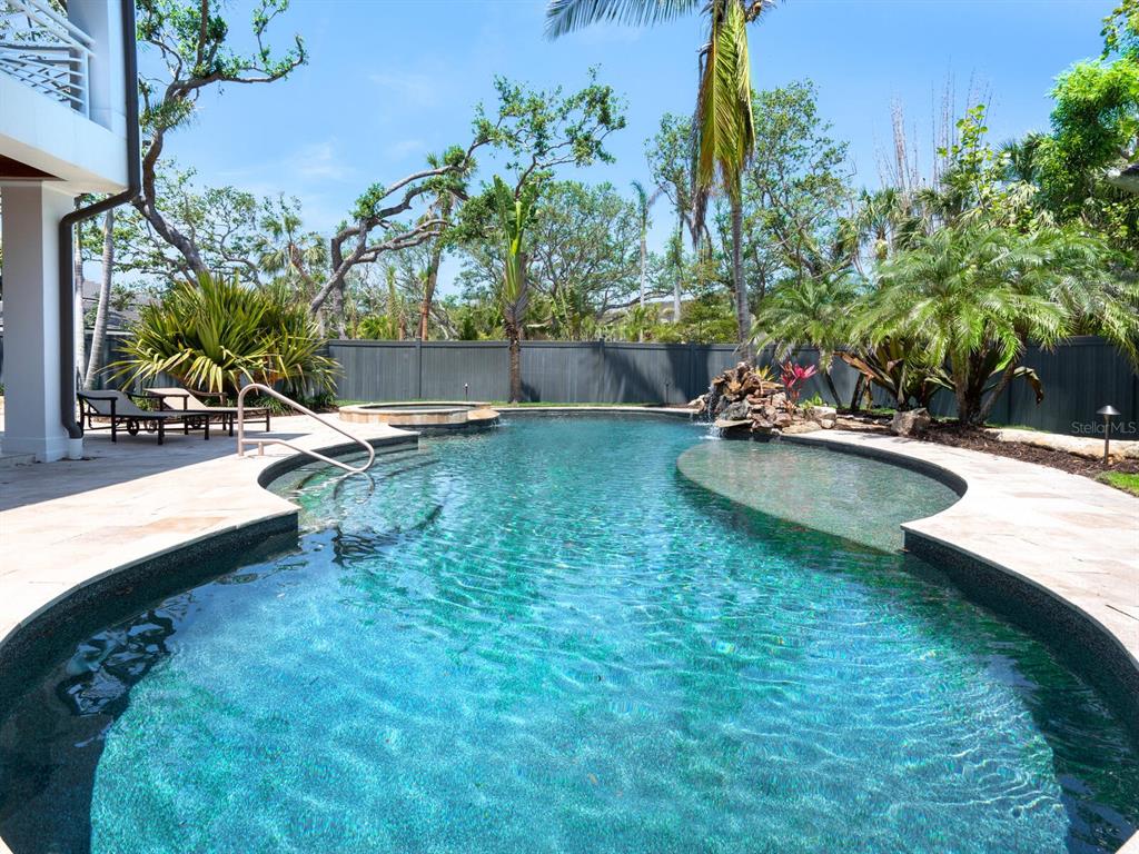 7333 Point Of Rocks Road Sarasota, FL 34242 - Photo 45 of 81 a view of a backyard with a patio and a garden