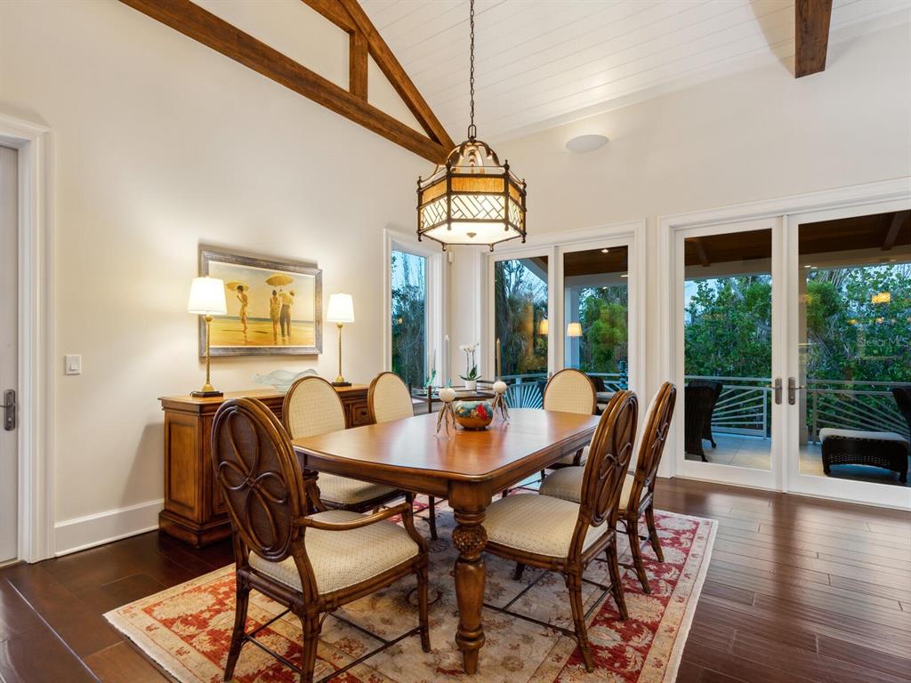 7333 Point Of Rocks Road Sarasota, FL 34242 - Photo 62 of 81 a view of a dining room with furniture wooden floor and chandelier
