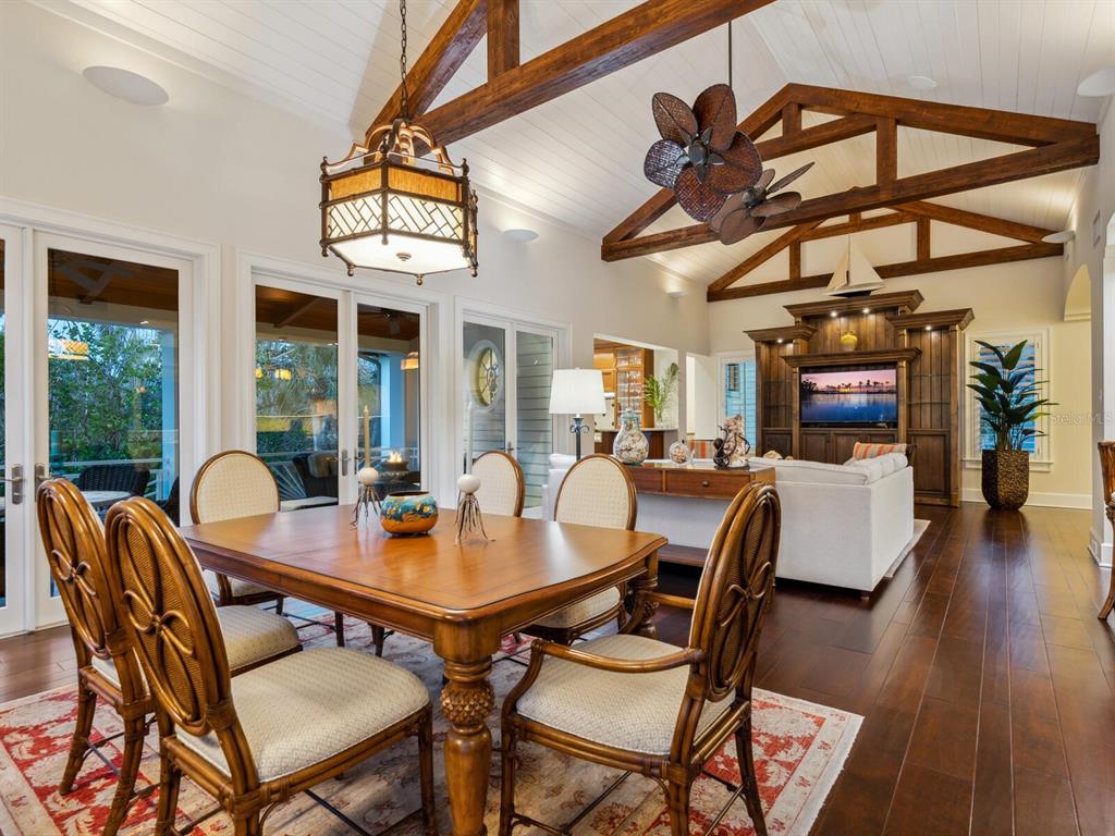 7333 Point Of Rocks Road Sarasota, FL 34242 - Photo 63 of 81 a view of a dining room with furniture wooden floor and chandelier