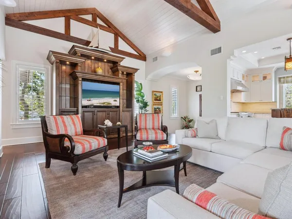 a living room with furniture a rug and a large window