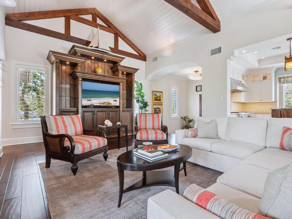 7333 Point Of Rocks Road Sarasota, FL 34242 - Photo 7 of 81 a living room with furniture a fireplace and a large window