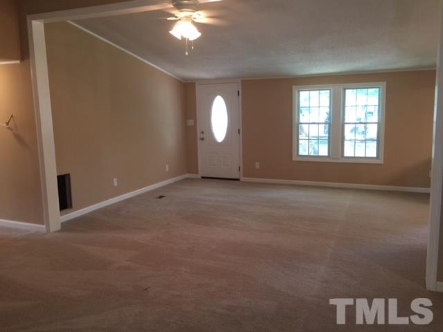 1390 Langdon Road Angier, NC 27501 - Photo 2 of 24 an empty room with windows and fan