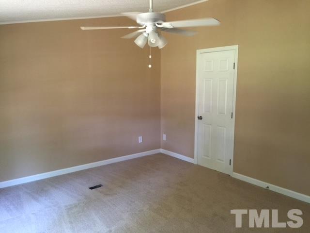 1390 Langdon Road Angier, NC 27501 - Photo 16 of 24 en empty room with windows and fan