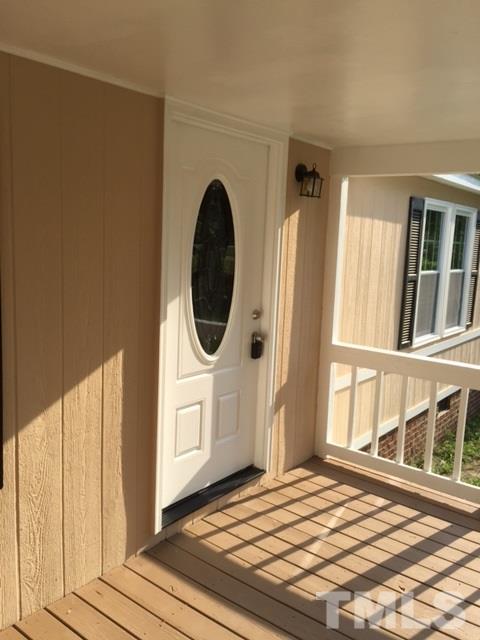 1390 Langdon Road Angier, NC 27501 - Photo 19 of 24 a view of a bedroom with wooden floor and windows