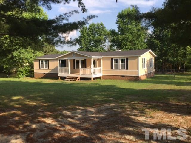 1390 Langdon Road Angier, NC 27501 - Photo 20 of 24 a front view of a house with a garden