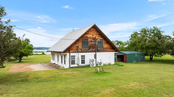 a view of a house with a yard and deck