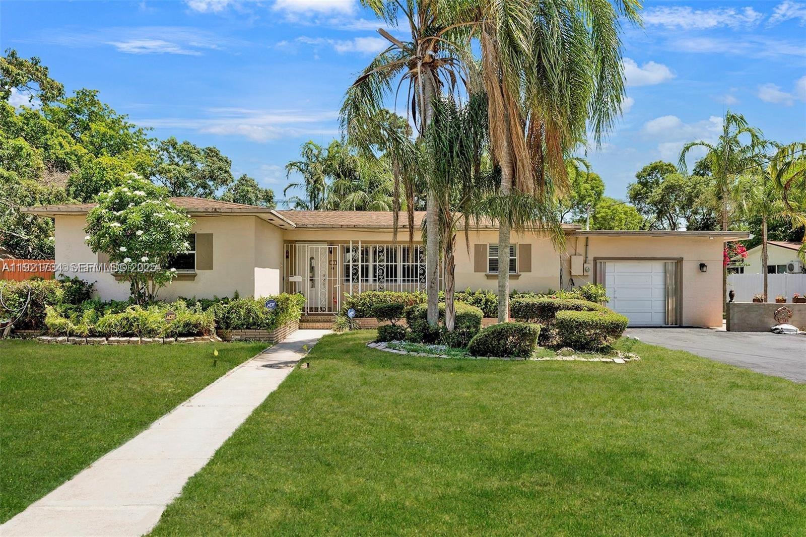 23 Southwest 8th Street Hallandale Beach, FL 33009 - Photo 3 of 18 a view of a house with a yard and sitting area
