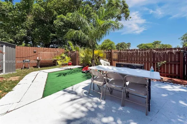 a view of a backyard with sitting area