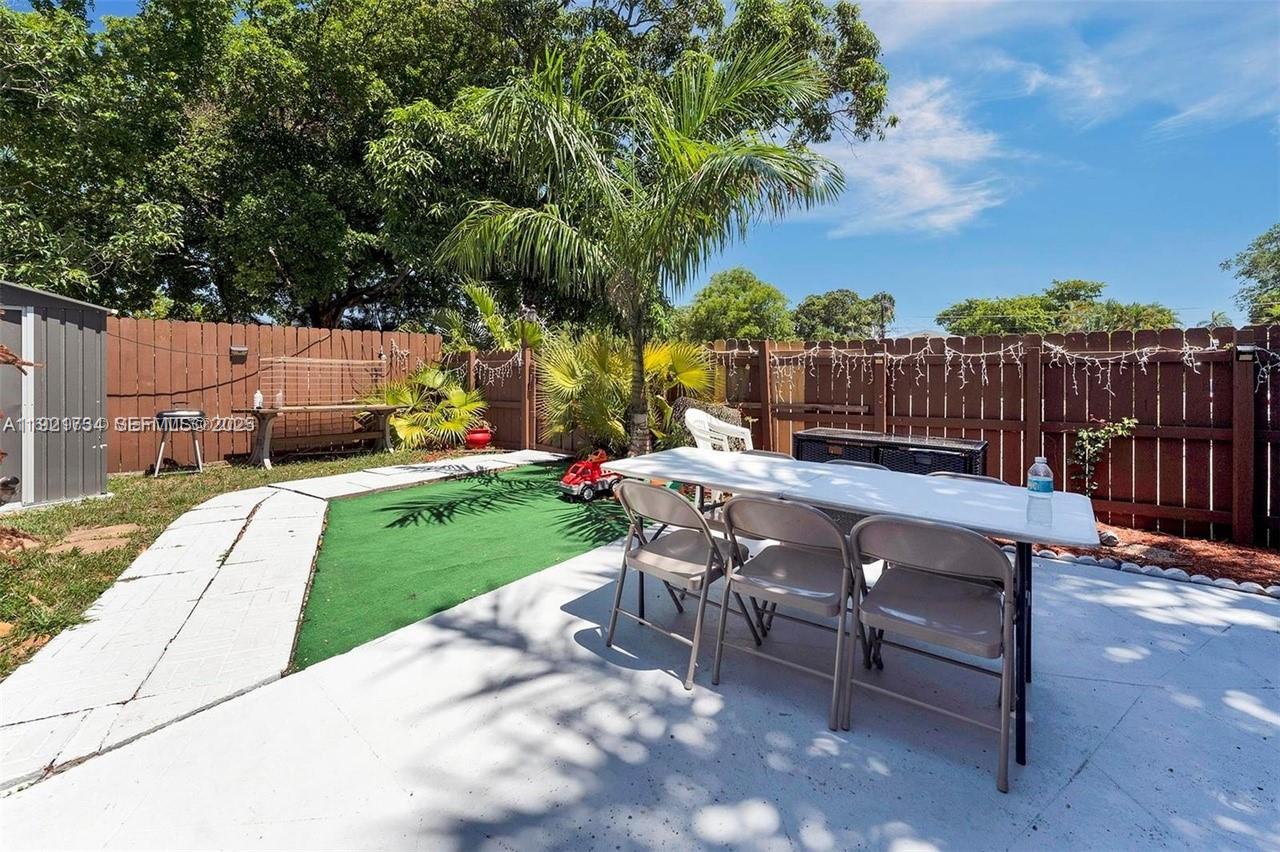 23 Southwest 8th Street Hallandale Beach, FL 33009 - Photo 6 of 18 a view of a backyard with sitting area
