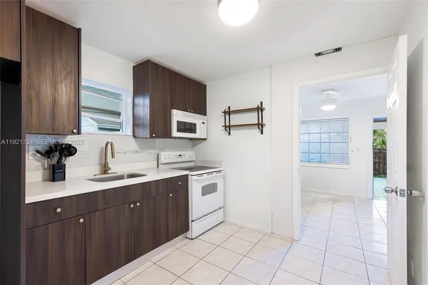 a kitchen with a sink cabinets and appliances