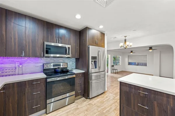 a kitchen with granite countertop stainless steel appliances and cabinets