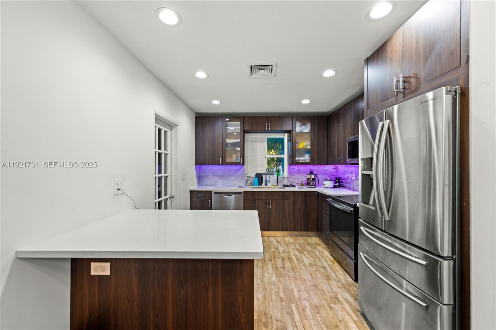 23 Southwest 8th Street Hallandale Beach, FL 33009 - Photo 10 of 18 a kitchen with stainless steel appliances a refrigerator and a stove