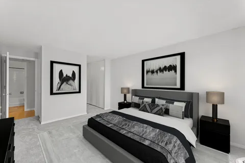 a bedroom with a bed and painting on the wall