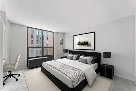 a bedroom with a bed and a lamp on table