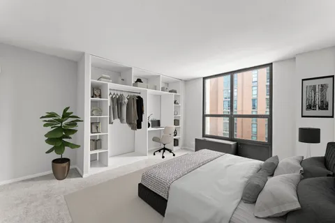 a bedroom with a bed and a potted plant