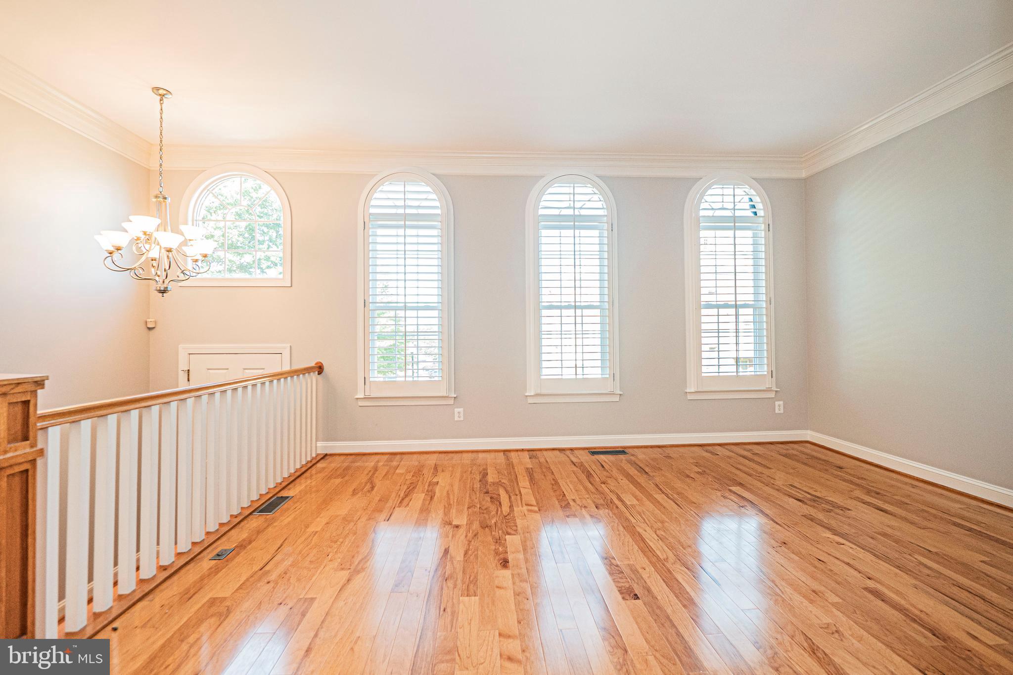 5448 Edsall Ridge Place Alexandria, VA 22312 - Photo 4 of 52 a view of an empty room with wooden floor and a window