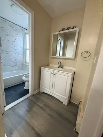 a bathroom with a sink a mirror and a bathtub