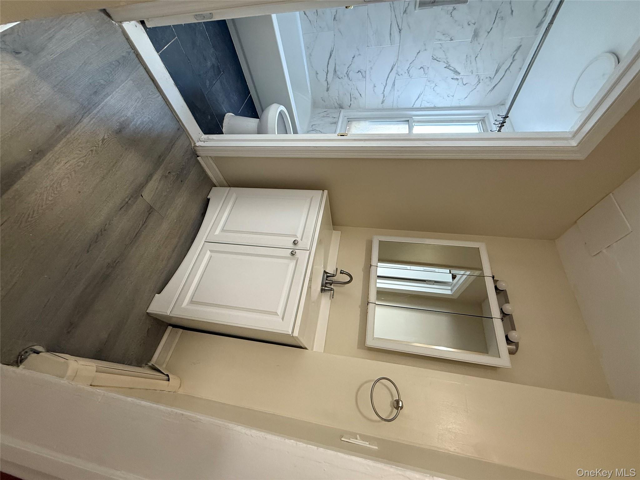 27 Balding Avenue, Unit 1 Poughkeepsie, NY 12601 - Photo 12 of 16 a bathroom with a sink a toilet and a mirror