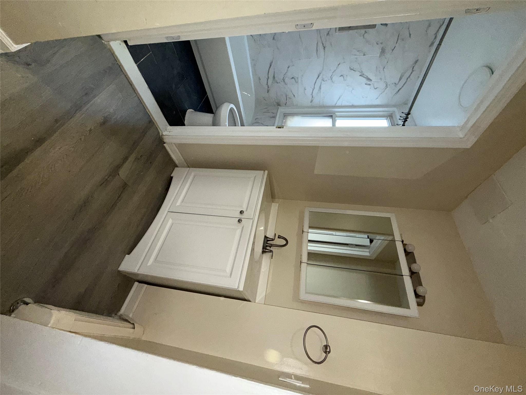 27 Balding Avenue, Unit 1 Poughkeepsie, NY 12601 - Photo 13 of 16 a bathroom with a sink a mirror and a bathtub
