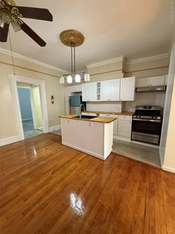 a living room with granite countertop furniture a fireplace and wooden floor