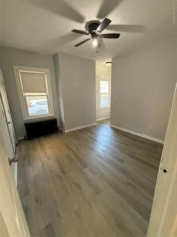wooden floor in an empty room with a window