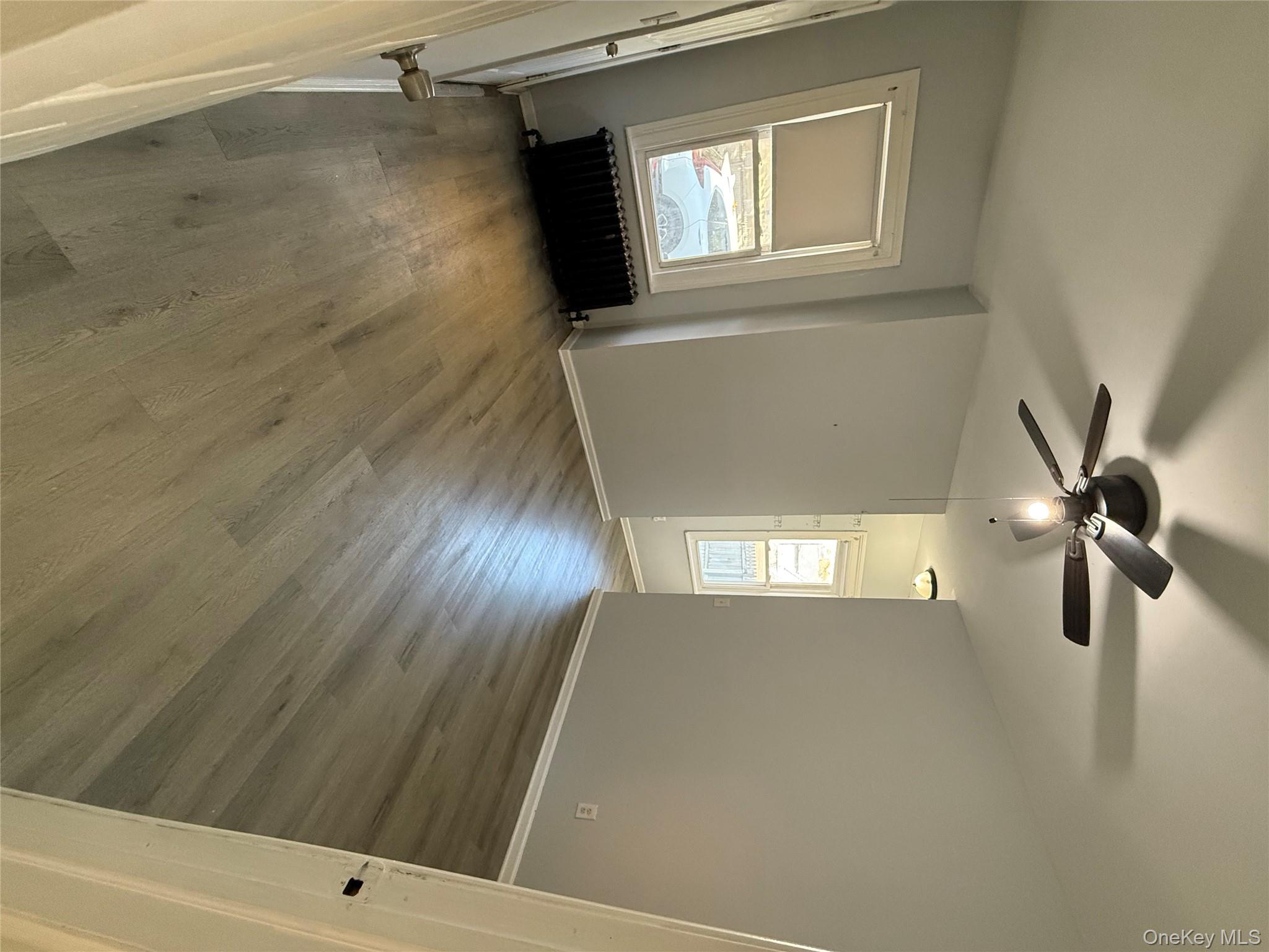 27 Balding Avenue, Unit 1 Poughkeepsie, NY 12601 - Photo 8 of 16 wooden floor in an empty room with a window
