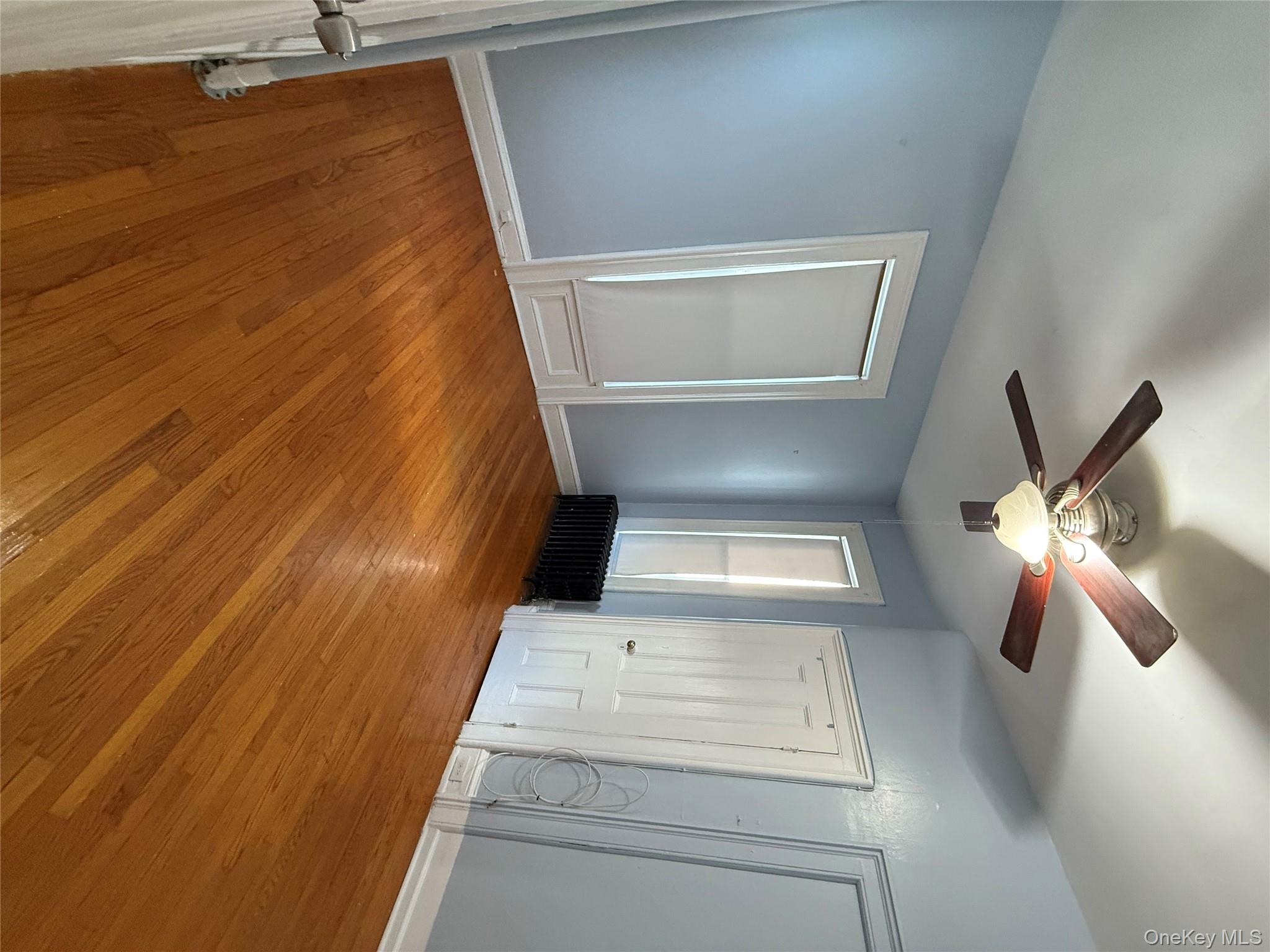 27 Balding Avenue, Unit 1 Poughkeepsie, NY 12601 - Photo 10 of 16 an empty room with wooden floor and windows