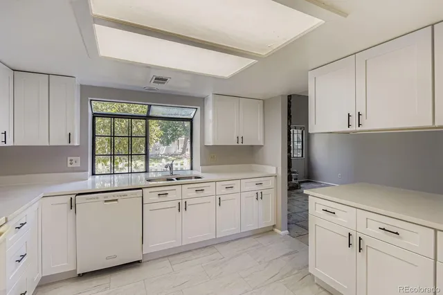 a kitchen that has a sink and a stove in it