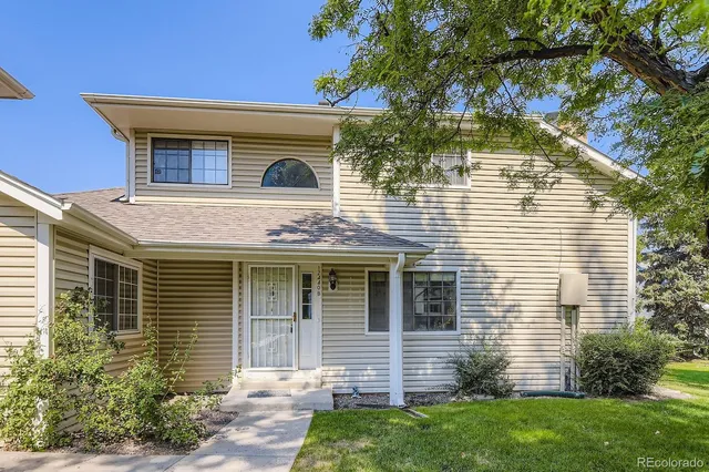 a front view of a house with a yard and outdoor seating