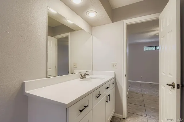 a bathroom with a sink a vanity and a mirror