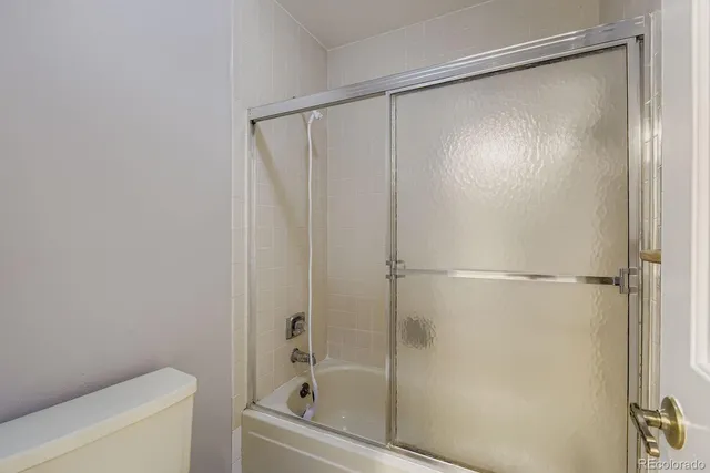 a bathroom with a shower and a toilet