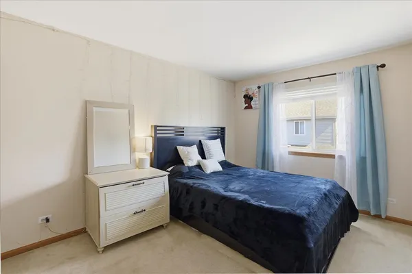 a bedroom with a bed and window