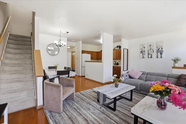 a living room with furniture kitchen view and a dining table