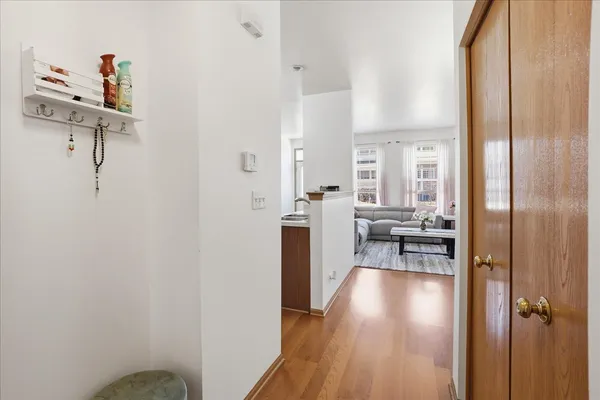 a view of a room with wooden floor and furniture