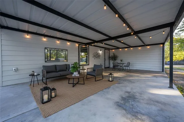 a living room with patio furniture and a wooden floor