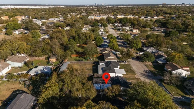 an aerial view of a houses with a city street
