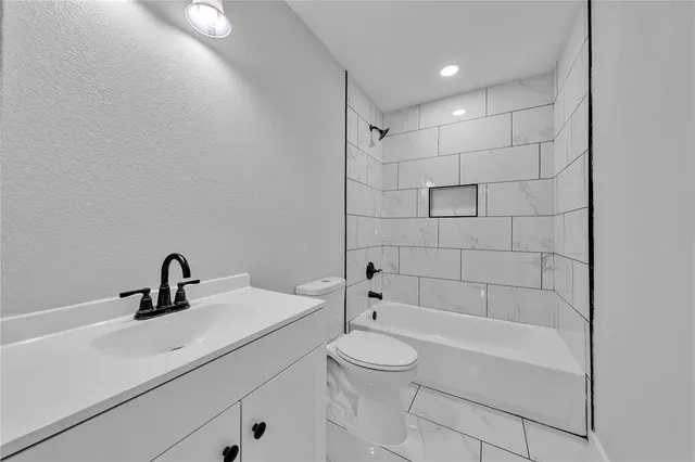 a bathroom with a sink a toilet and bathtub