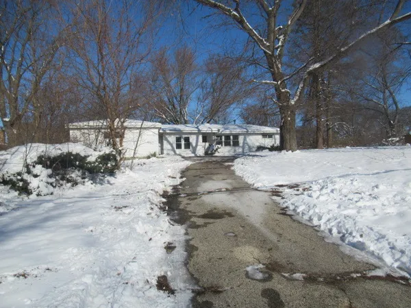 a view of a yard with snow on the road