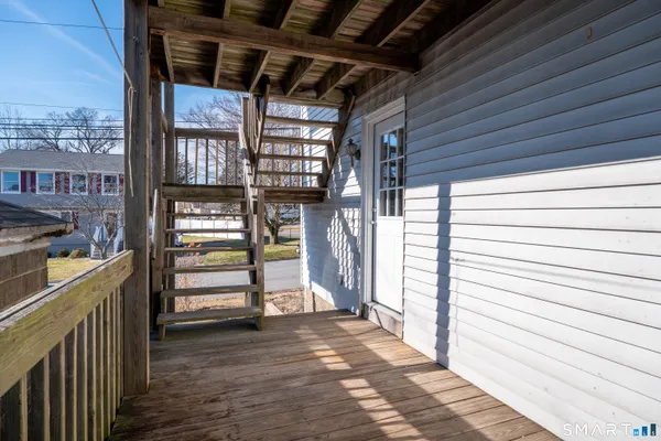 a view of a porch with wooden floor