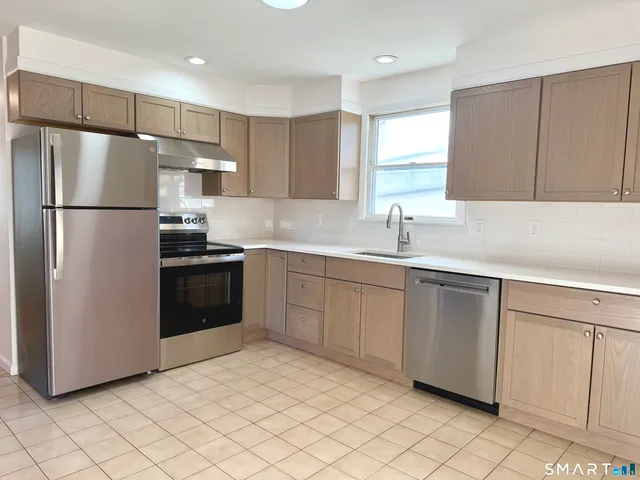 a kitchen with a sink appliances and cabinets