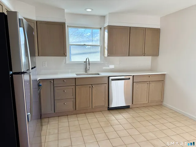 a kitchen with a sink cabinets and stainless steel appliances