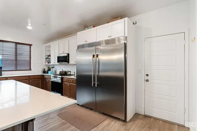 a kitchen with granite countertop a refrigerator and a sink